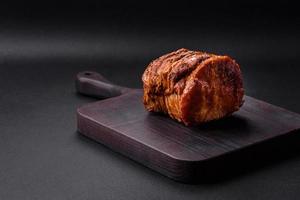 Delicious fresh smoked meat or ham with spices and herbs photo