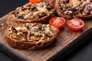 Delicious crispy toast or bruschetta with fried onion, champignon mushrooms and cheese photo