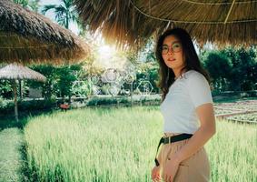 Portrait of young woman in the rice field. Traveling to clean places of Earth and discovering beauty of nature. Organic Agriculture and Saving environment, ecology concept. Card for World Earth Day. photo