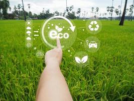 Environmental technology concept. Eco technology pointing. Connecting technology to save the earth. Green background. ECO icon is bright. photo