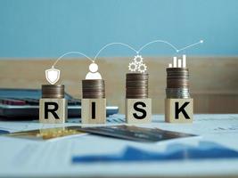 wooden blocks with risk words The concept of risk management, the work of an enterprise business that is on risk. photo