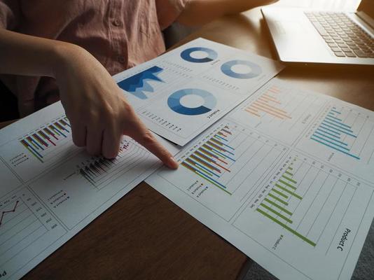 Businesswoman pointing at a graph online meeting planning to work working from home