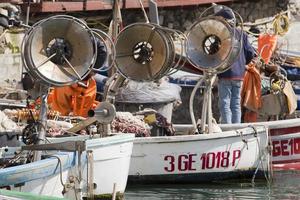 Fishing wooden boat mooring at the harbor photo