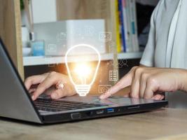 Light bulb with global internet connection on laptop showing strategic planning analysis and development modern concept ideas photo