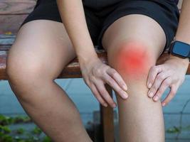 Young woman showing pain from joints of the body. Red dots. photo