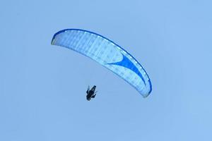 hang glider in the blue sky photo