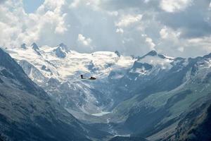 glider over swiss alps glacier view in Engadina photo