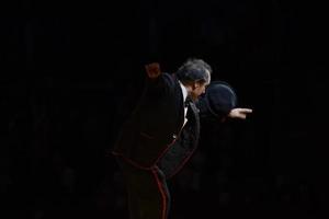 Circus performer in the black background photo