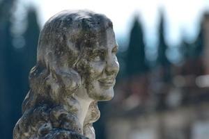 young lovers while smiling marble statue photo