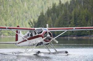 A Floatplane while landing on Alaskan lake photo