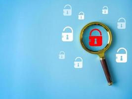 security search with magnifying glass security padlock red system weaknesses on a blue background photo