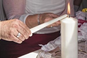 marriage candles holded by bride and husband photo