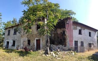 old abandoned roof collapsed farm house building in italy photo