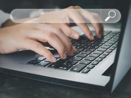 Search a young woman using a laptop to search for information using Search Console, a large database technology access to information. photo