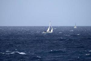 sail boat in high waves sea photo
