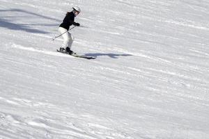 skier skiing with good style in dolomites snow mountains photo