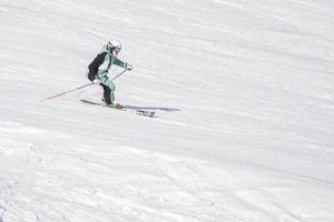 skier skiing with good style in dolomites snow mountains photo