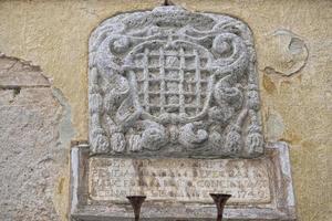 san quirico medieval houses stone wall vatican bas relief photo