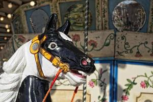 old vintage carousel wooden horse detail photo