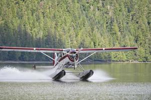 A Floatplane while landing on Alaskan lake photo