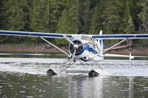 A Floatplane while landing on Alaskan lake photo