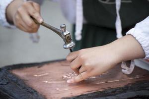 hands working copper photo