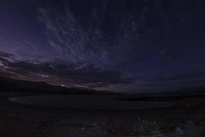 tent camp in desert sandy beach in california at night photo