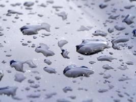 rain water drops on blue metallic surface photo