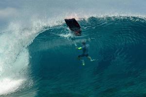 Surfer inside wave tube in Polynesia photo