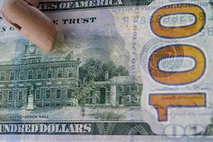 wooden hand holding dollars close up detail macro photo