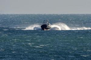 Full speed boat on rough sea photo