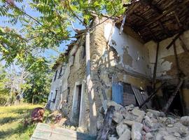 old abandoned roof collapsed farm house building in italy photo