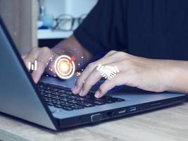 Businessman showing a laptop computer business success goals business goal icon on laptop photo