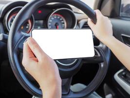 woman using phone while driving with one hand photo