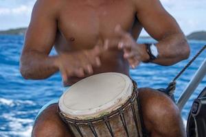 bora bora hombre polinesio tocando tambor en barco foto