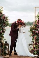 wedding ceremony of the newlyweds on the pier photo