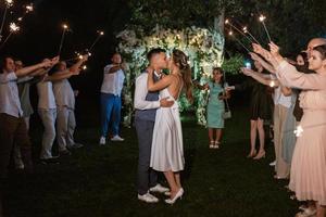 newlyweds at a wedding of sparklers photo