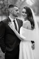 newlyweds walk in the park among cherry blossoms photo