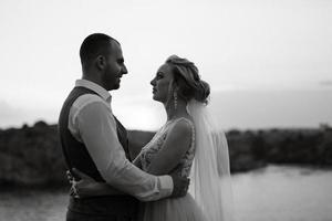 bride blonde girl and groom near the river photo