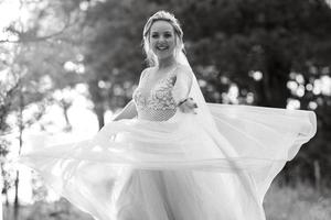 bride blonde girl with a bouquet in the forest photo