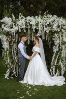 wedding ceremony of the newlyweds on the glade photo