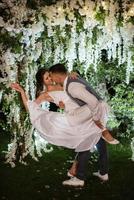 couple of newlyweds on the evening illuminated arch photo