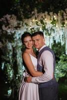 couple of newlyweds on the evening illuminated arch photo