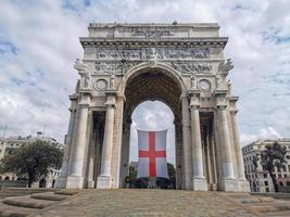 triunfo arco en Génova con bandera rojo cruzar en blanco foto