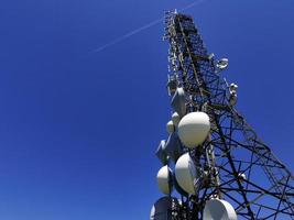 telecom cellular Communication Antenna tower on blue background photo