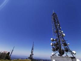 telecom cellular Communication Antenna tower on blue background photo