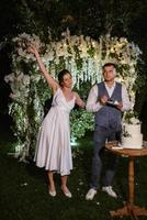 newlyweds happily cut and taste the wedding cake photo