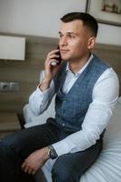 portrait of the groom in a light gray suit photo