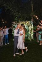 newlyweds at a wedding of sparklers photo