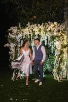 couple of newlyweds on the evening illuminated arch photo